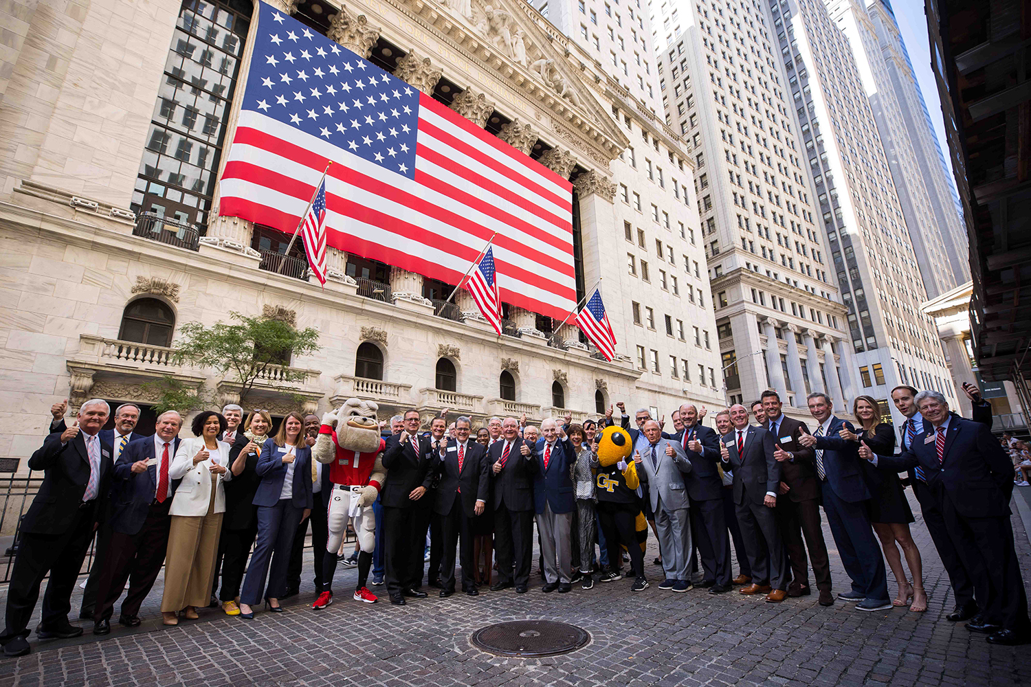 people and college mascots out in front of the nyse